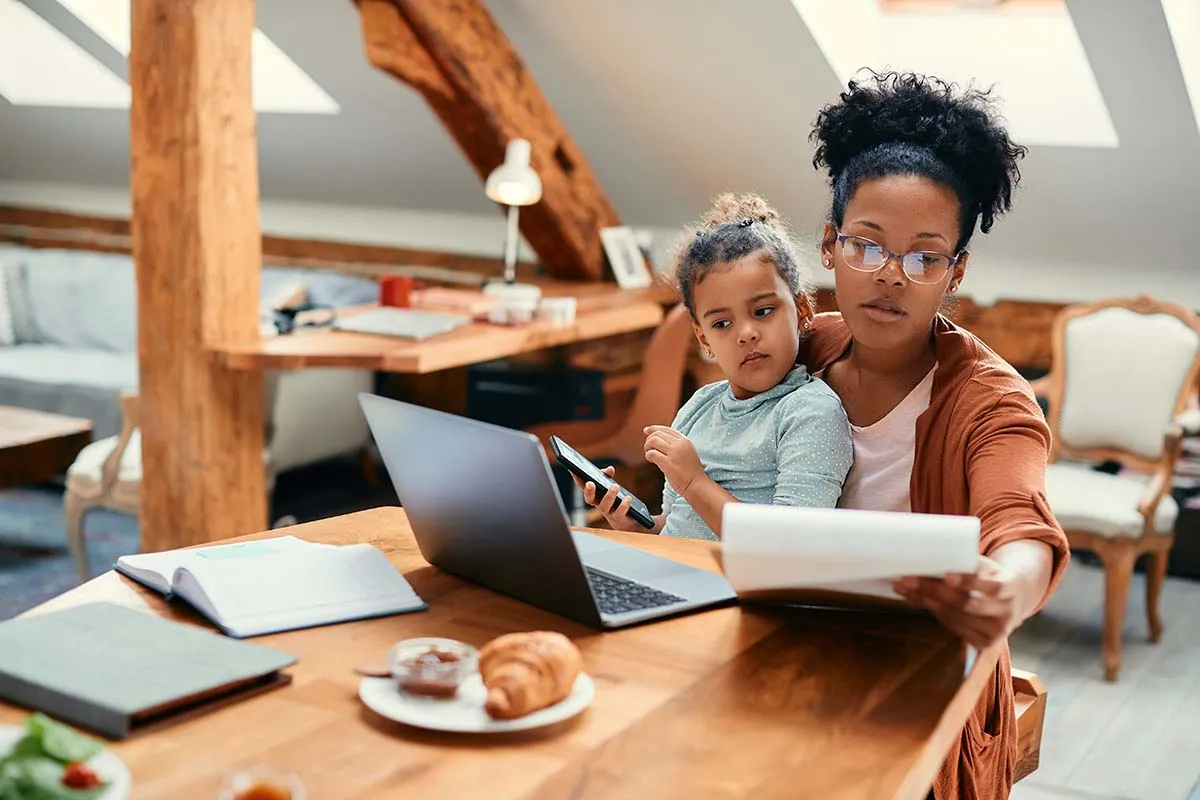 Woman holding child and doing , understanding an audit reconsideration 