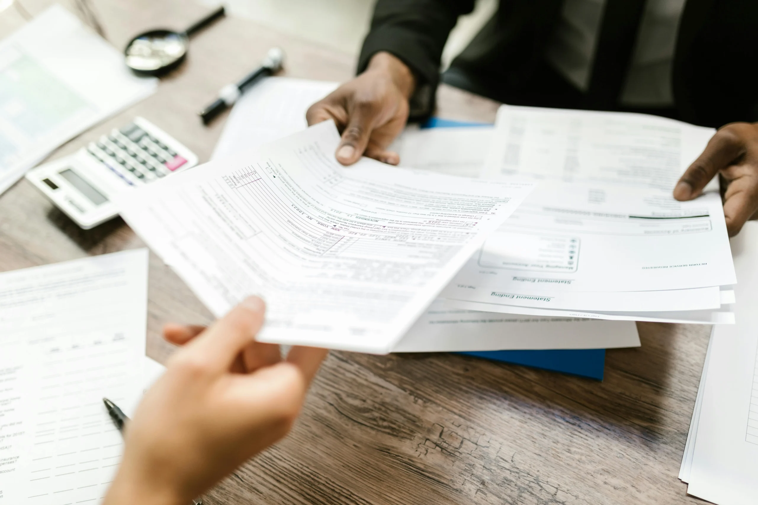 Lawyer handing tax forms to client.