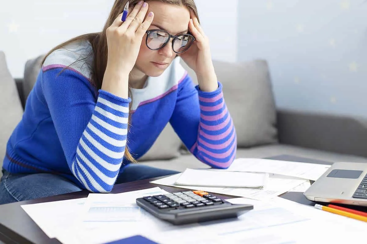 stressed woman analyzing spouse's tax liability